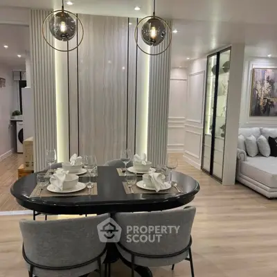 Modern dining area with elegant table setting and stylish lighting in a contemporary apartment.