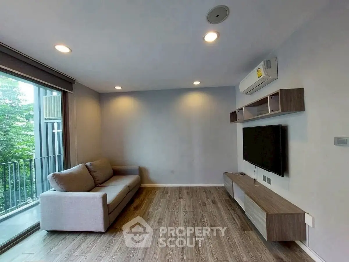 Modern living room with sleek design and balcony view