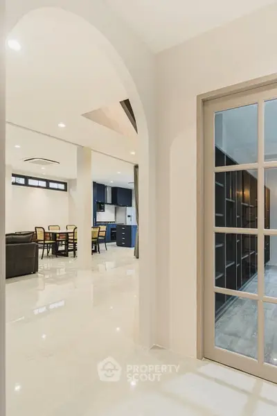 Spacious open layout living and dining area with modern kitchen design.