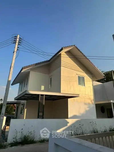 Modern two-story house with minimalist design and spacious outdoor area.