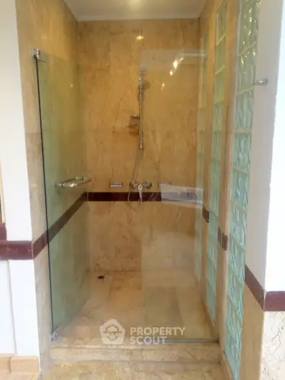 Elegant marble shower with glass doors in a modern bathroom