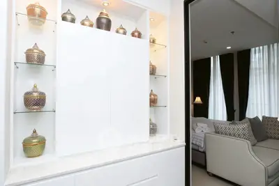 Elegant living room with decorative display and cozy seating area