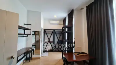 Modern study room with sleek furniture and ample natural light, perfect for productivity and comfort.