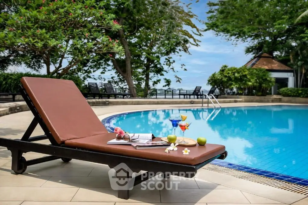 Luxurious poolside retreat with sun loungers and refreshing drinks, perfect for relaxation.