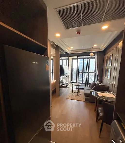 Modern apartment interior with open layout and city view from balcony.