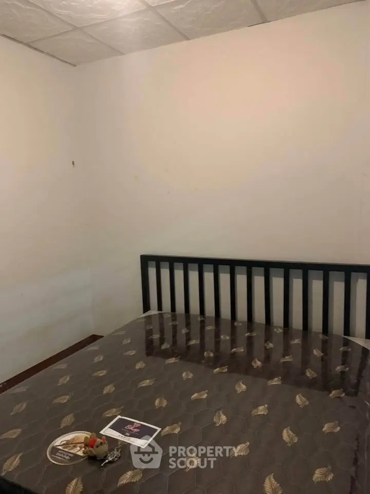 Cozy bedroom with simple decor and a comfortable bed, perfect for restful nights.