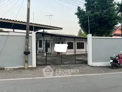 Charming single-story home with gated entrance and spacious driveway.