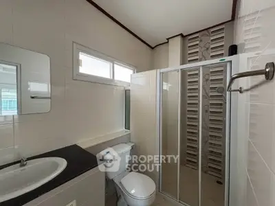 Modern bathroom with sleek shower and contemporary fixtures in a stylish home.
