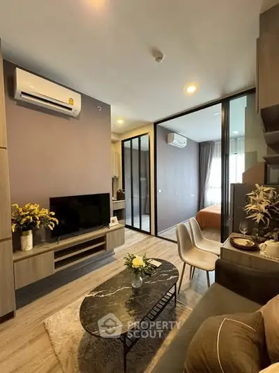 Modern living room with stylish decor and open layout to bedroom