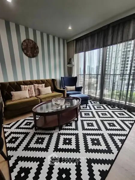 Stylish living room with modern decor and city view balcony.