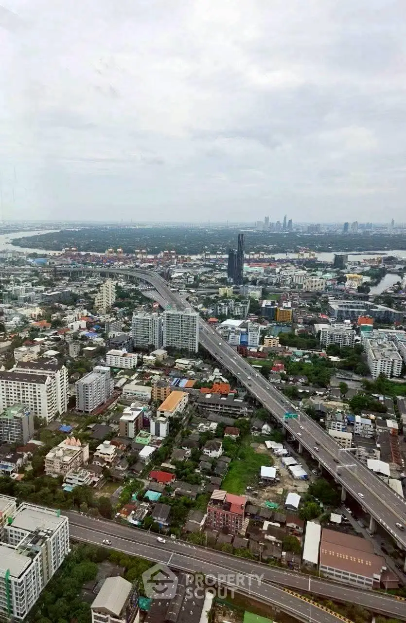 Stunning aerial view of urban landscape with highways and skyscrapers, showcasing vibrant city life and development.