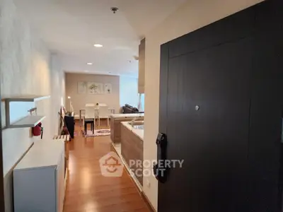 Modern open-plan living and dining area with wooden flooring and stylish decor.