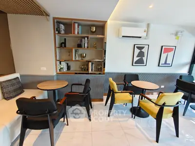 Modern living room with stylish furniture and built-in bookshelf, perfect for relaxation and entertainment.