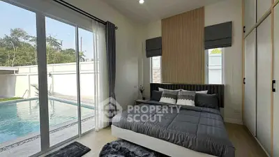 Luxurious bedroom with pool view and modern decor in a stylish home