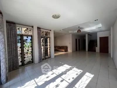 Spacious living room with large windows and natural light