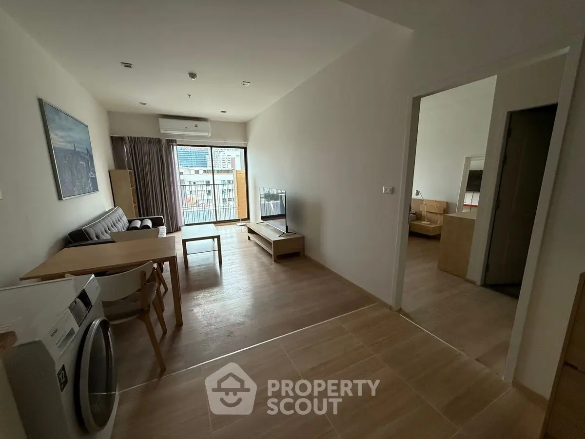 Modern apartment with open living area and city view balcony