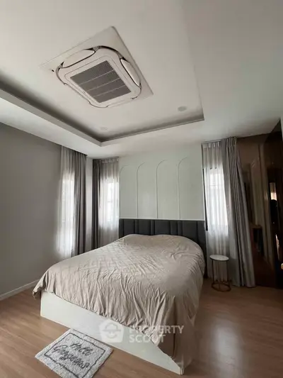 Modern bedroom with stylish ceiling design and cozy ambiance
