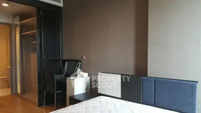 Modern bedroom with stylish headboard and adjacent study area