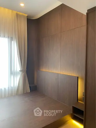 Modern bedroom with elegant wood paneling and ambient lighting