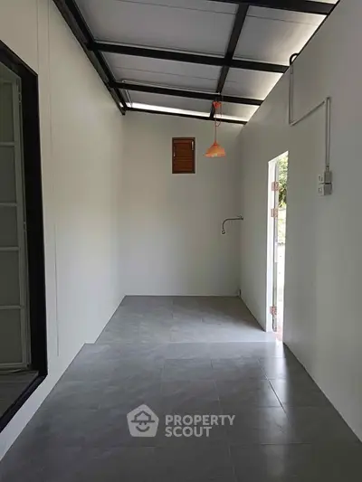 Minimalist interior space with high ceiling and modern lighting