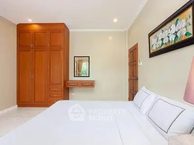 Spacious bedroom with elegant wooden wardrobe and cozy decor