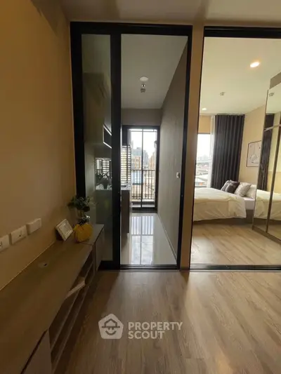 Modern apartment interior with wooden flooring and city view balcony