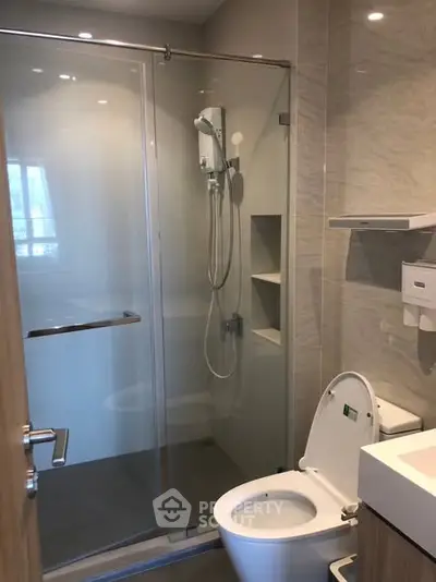 Modern bathroom with glass shower and sleek fixtures