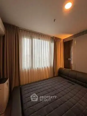 Cozy bedroom with modern decor and ample natural light