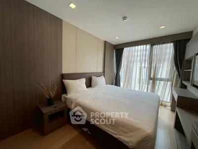 Modern bedroom with large window and stylish decor, featuring a comfortable bed and wooden accents.