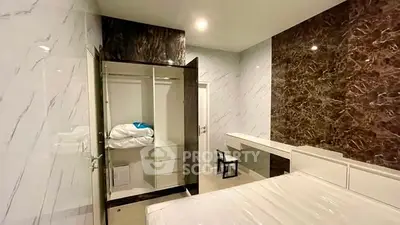 Luxurious bedroom with modern marble accents and built-in closet