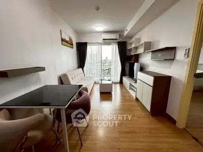 Modern living room with stylish furniture and balcony view in a cozy apartment.