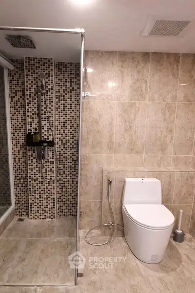 Modern bathroom with glass shower and elegant tile design