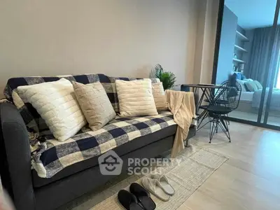 Cozy living room with stylish sofa and modern decor in a contemporary apartment.