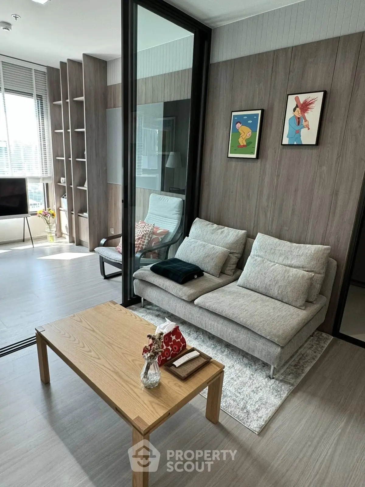 Modern living room with stylish decor and natural light in a high-rise apartment.