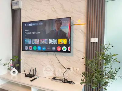 Modern living room with wall-mounted TV and sleek entertainment setup
