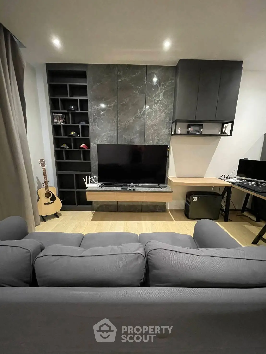 Modern living room with sleek entertainment center and cozy gray sofa