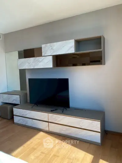 Modern living room with sleek TV unit and stylish wall cabinets