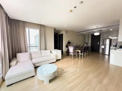 Spacious modern living room with elegant dining area and open kitchen layout