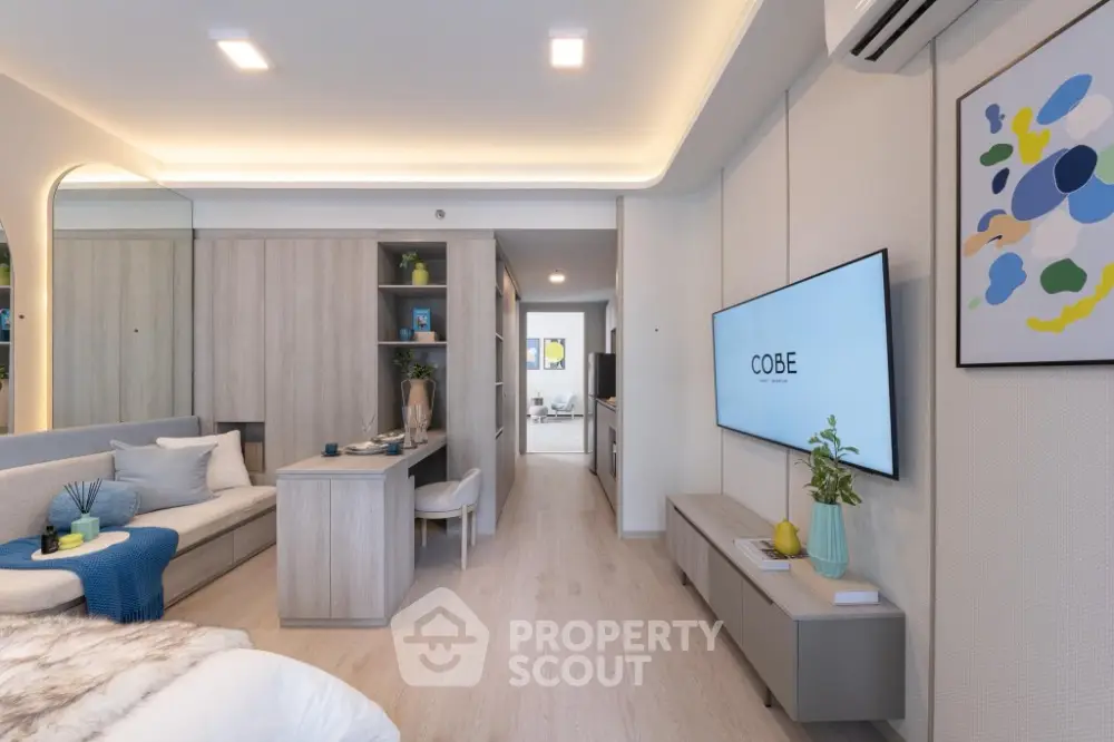 Modern living room with sleek design, featuring a wall-mounted TV and stylish decor.