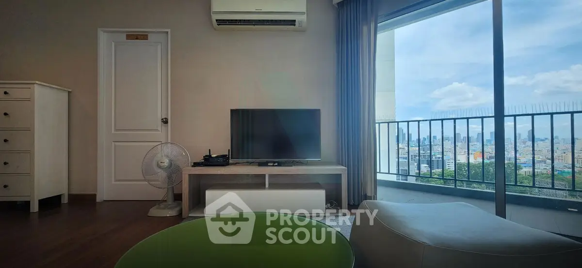 Modern living room with city view, featuring air conditioning and stylish furniture.