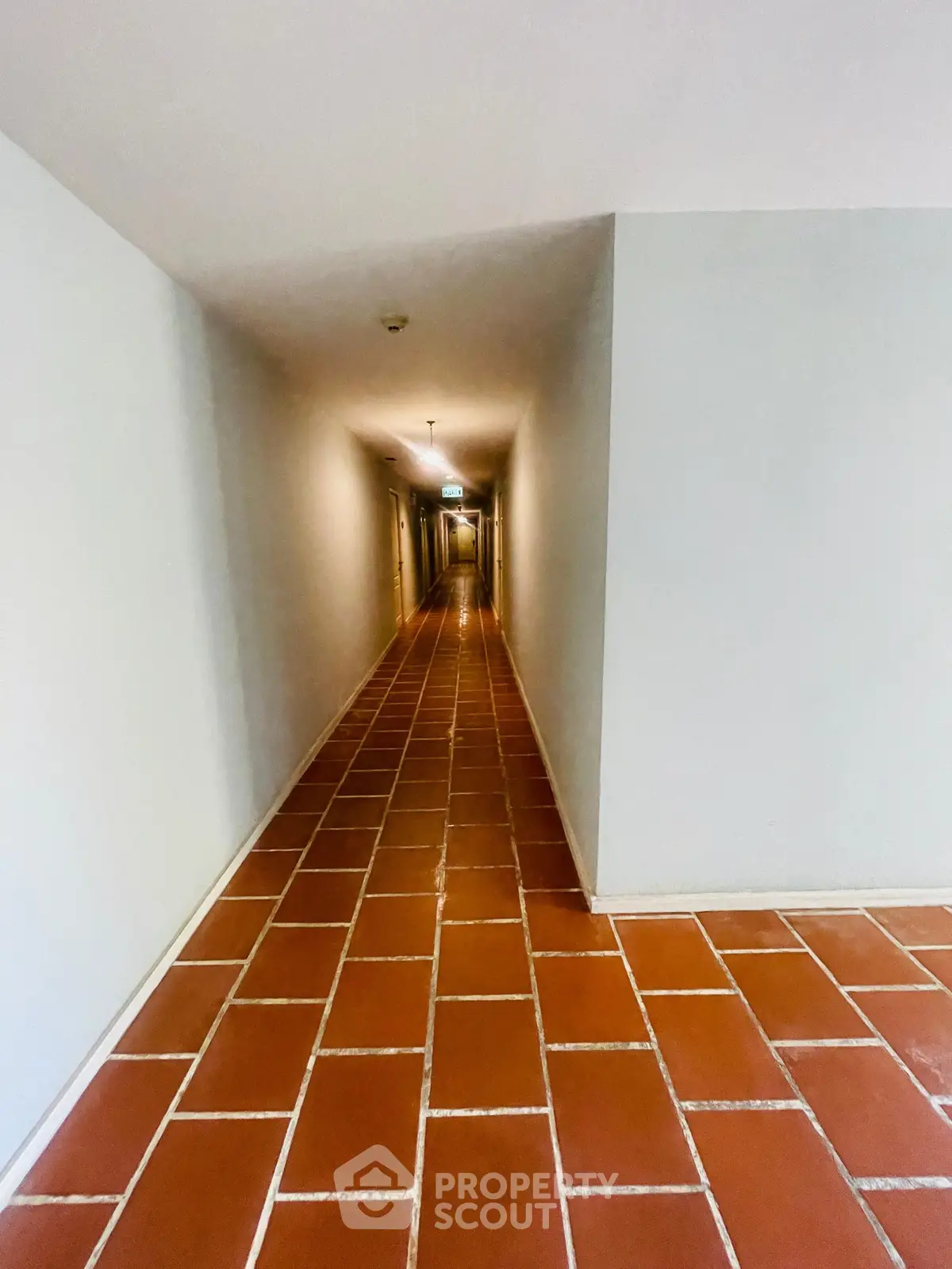 Spacious corridor with terracotta tiles in modern building