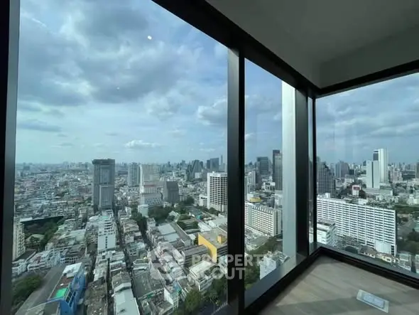 Stunning cityscape view from a high-rise corner unit with floor-to-ceiling windows.