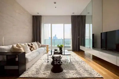 Luxurious modern living room with city view, elegant decor, and floor-to-ceiling windows.