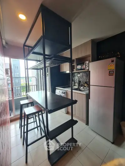 Modern kitchen with sleek appliances and open layout in stylish apartment