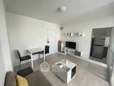 Modern living room with sleek furniture and open kitchen layout