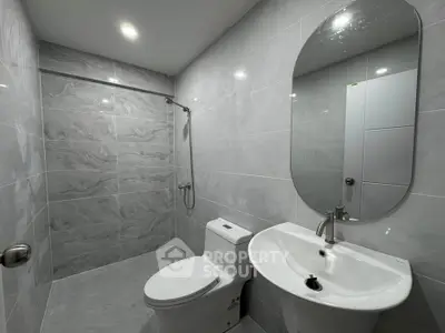 Modern bathroom with sleek gray tiles and elegant fixtures