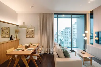 Modern living room with dining area and city view balcony in luxury apartment.