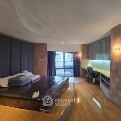 Spacious bedroom with modern design and city view balcony access