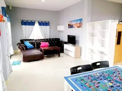 Spacious living room with modern decor and cozy seating area.