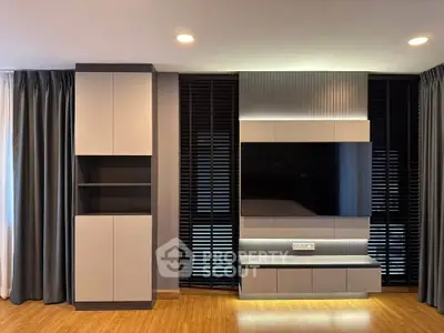 Modern living room with sleek cabinetry and wall-mounted TV setup